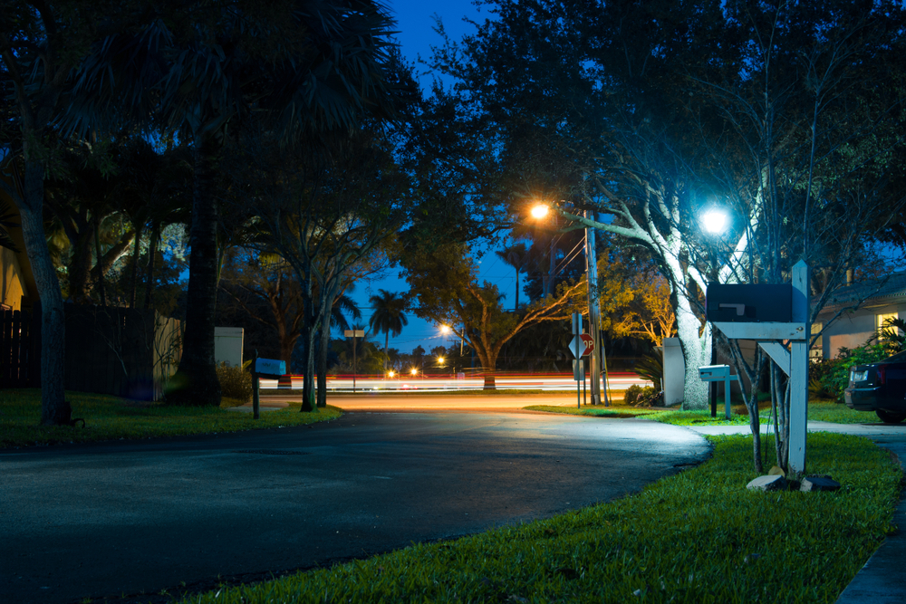nighttime on a neighborhood street with mailbox and lights